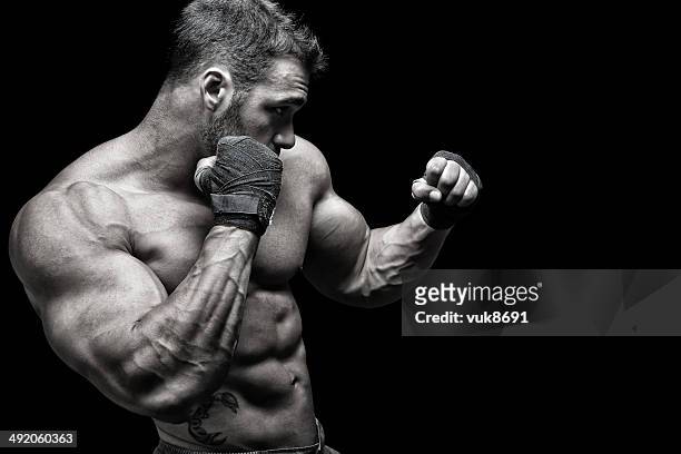 powerful fighter - mixed martial arts stock pictures, royalty-free photos & images