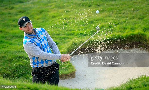 Branden Grace of South Africa and the International Team plays his second shot goes left on the sixth hole in his match with Louis Oosthuizen against...