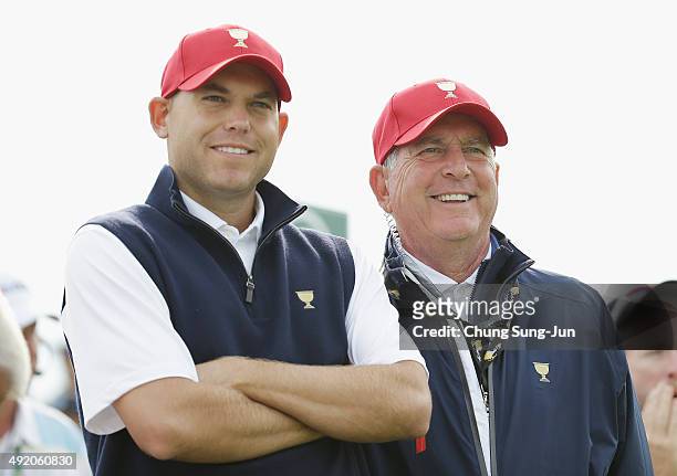 Captain Jay Haas of the United States Team watches the play alongside his son Bill on the eighth tee during the Saturday foursomes matches at The...