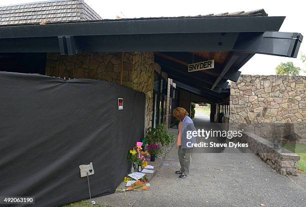 Visitor pauses at a makeshift memorial outside of Snyder Hall on the Umpqua Community College Campus on October 9, 2015 in Roseburg, Oregon. Snyder...