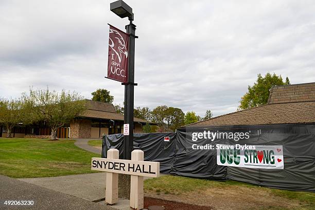Sign of support hangs on the black plastic tarp that covers Snyder Hall on the Umpqua Community College Campus on October 9, 2015 in Roseburg,...