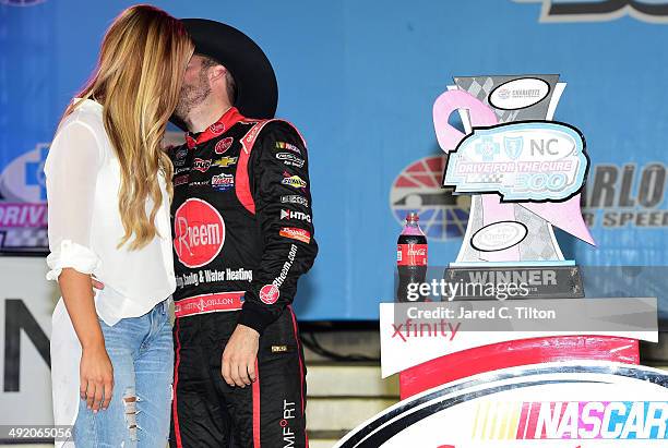 Austin Dillon, driver of the Rheem Chevrolet, celebrates in victory lane with his girlfriend and Titans cheerleader Whitney Ward after winning the...