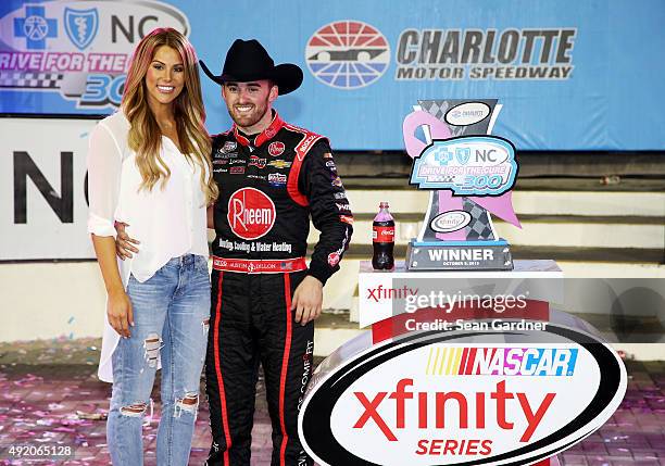 Austin Dillon, driver of the Rheem Chevrolet, celebrates in victory lane with his girlfriend and Titans cheerleader Whitney Ward after winning the...