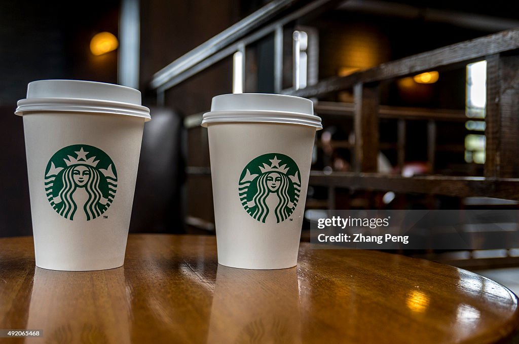 Coffee cup on table in a Starbucks cafe.  Starbucks is...