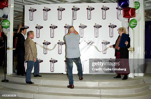 Rick Harrison from History's "Pawn Stars" television series cuts the ceremonial ribbon with a sword as Republican presidential candidate Sen. Marco...