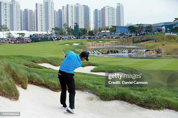 Charl Schwartzel of South Africa and the International Team fails to get his ball out of the fairway bunker for his second shot on the 18th hole in...