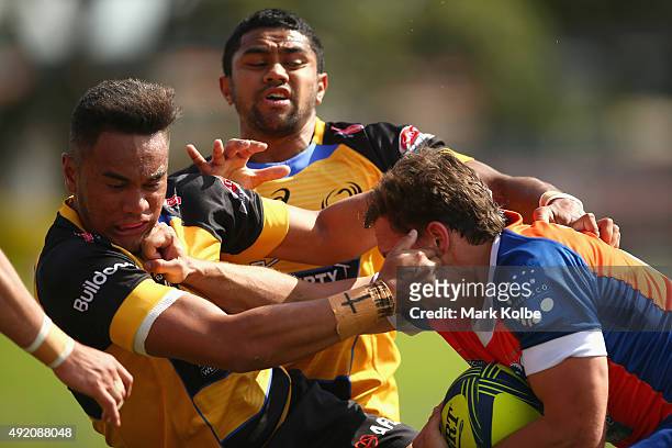 Faamanatu Apineru of the Spirit is bumped away by Brenden Hartmann of the Rams as he attemptes a tackleduring the round eight NRC match between the...