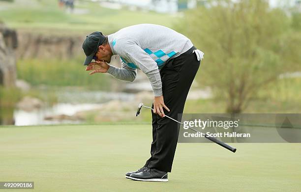 Adam Scott of Australia and the Internaional Team reacts to a putt on the 18th green during the Saturday foursomes matches at The Presidents Cup at...