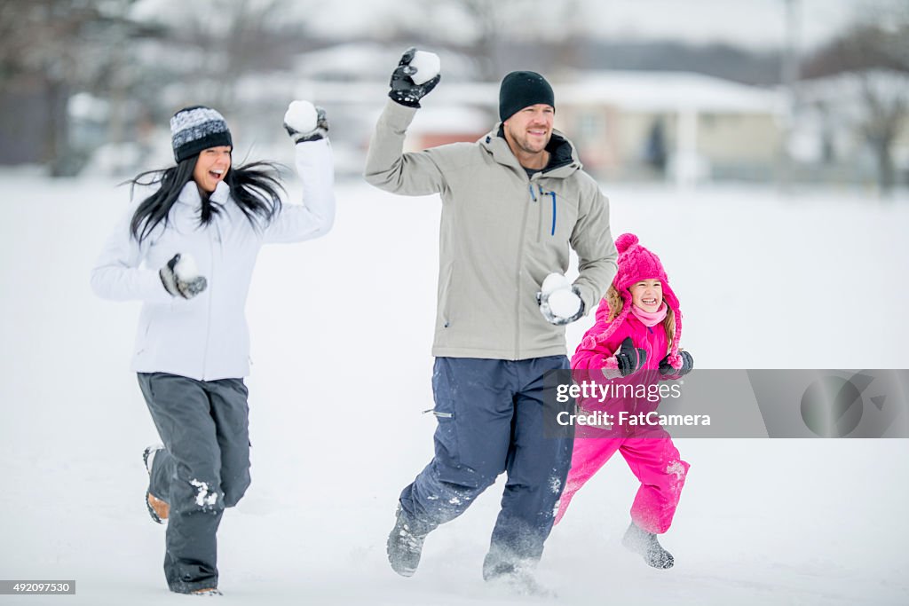 Chasing Each Other in a Family Snowball Fight