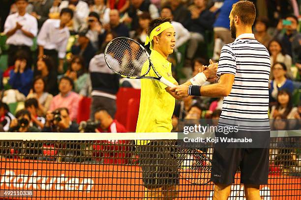 Kei Nishikori of Japan shakes hands with Benoit Paire of France after the men's singles semi final match on Day Six of the Rakuten Open 2015 at...