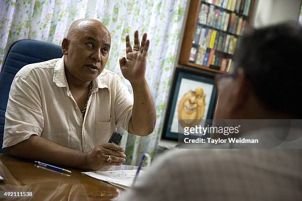 Astrologer San Zarni Bo meets with a client concerned about an illness in his family on October 10, 2015 in Yangon, Myanmar. Astrology and fortune...