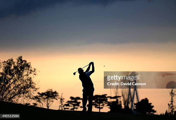 Phil Mickelson of the United States team plays his second shot on the 15th fairway as the sun sets during the Saturday afternoon fourball matches at...