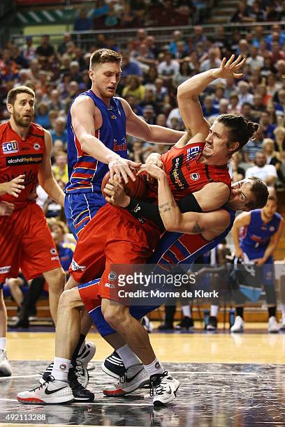 Nathan Sobey of the 36ers tackles Greg Hire of the Wildcats during the round one NBL match between Adelaide 36ers and the Perth Wildcats at Adelaide...