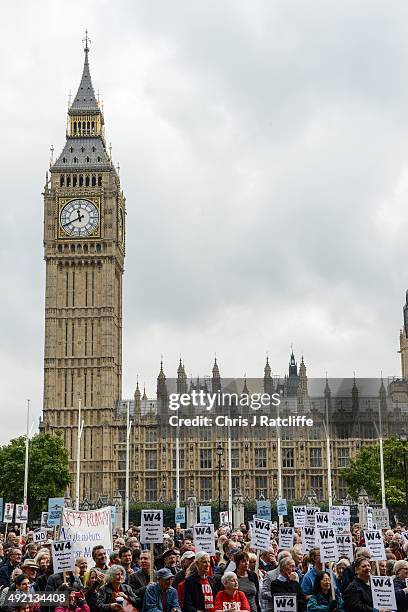Protesters hold signs during a rally against a third runway at Heathrow airport, in Parliament Square on October 10, 2015 in London, England. Before...