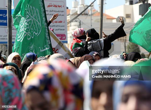 Palestinian women protesters take a selfie during a demonstration in support of Palestinians in the West Bank and against Jewish groups visiting the...