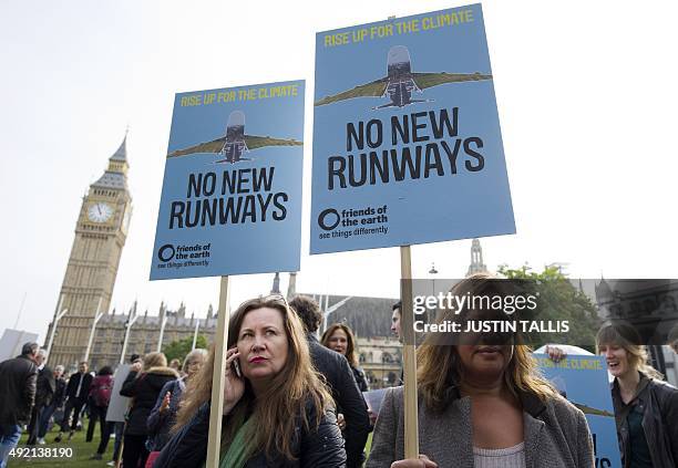 Protesters against a proposed expansion of Heathrow Airport gather at a rally in Parliament Square in London on October 10, 2015. Prime Minister...