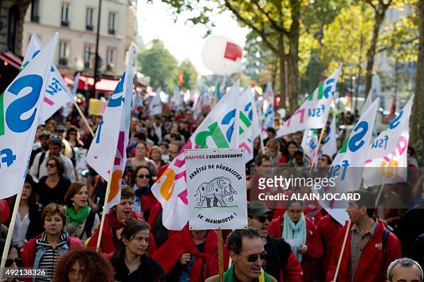 People wave flags during a demonstration in Paris on October 10 against proposed middle school reforms. Several thousand teachers participated in the...