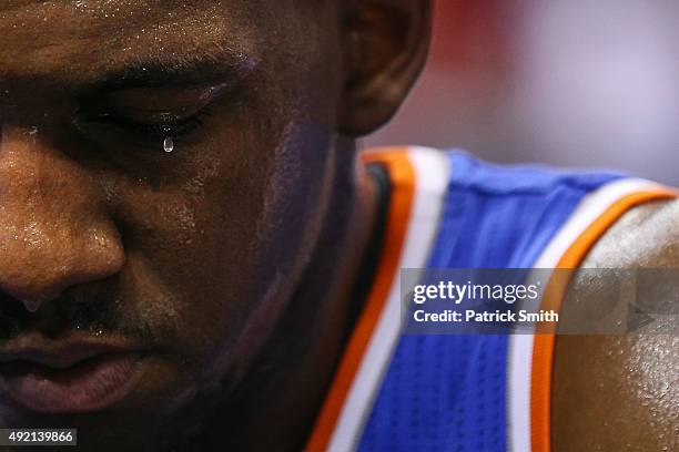 Langston Galloway of the New York Knicks has sweat drip from his eye as he sits on the bench during a timeout against the Washington Wizards in the...