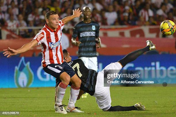 Andres Felipe Correa of Junior struggles for the ball Santiago Trellez of Atletico Nacional during the Final First Leg Match between Junior and...