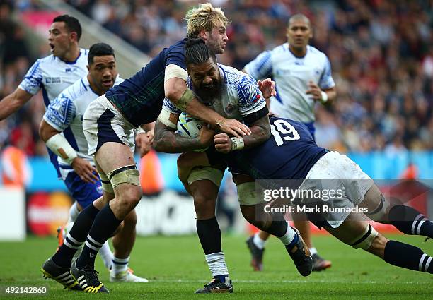 Faifili Levave of Samoa is tackled by Johnny Grey and Tim Swinton of Scotland during the 2015 Rugby World Cup Pool B match between Samoa and Scotland...