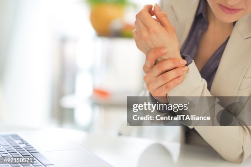 Closeup on business woman with wrist pain Closeup on business woman with wrist pain