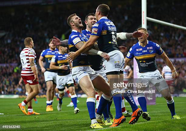 Danny McGuire of the Leeds Rhinos celebrates with team mates after scoring his teams first try against of the Wigan Warriors during the First Utility...