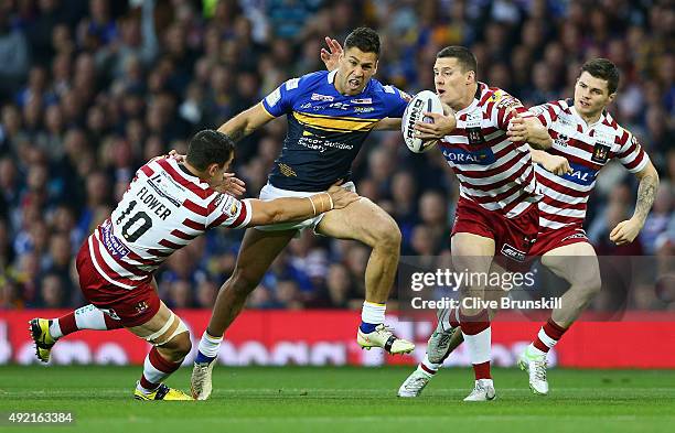 Joel Moon of the Leeds Rhinos is tackled by Ben Flower of the Wigan Warriors during the First Utility Super League Grand Final between Wigan Warriors...