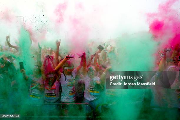 Runners celebrate in the Festival Area after The Color Run on October 10, 2015 in Brighton, England. The Color Run took place at Brighton's Madeira...