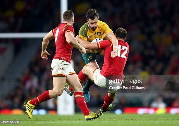 Adam Ashley-Cooper of Australia is tackled by Jamie Roberts of Wales during the 2015 Rugby World Cup Pool A match between Australia and Wales at...