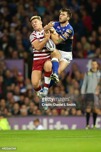 George Williams of Wigan Warriors and Tom Briscoe of Leeds Rhinos collide as they jump for the ball during the First Utility Super League Grand Final...