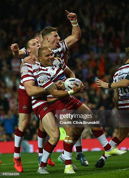 Matthew Bowen of the Wigan Warriors celebrates with team mates after scoring his teams third try during the First Utility Super League Grand Final...