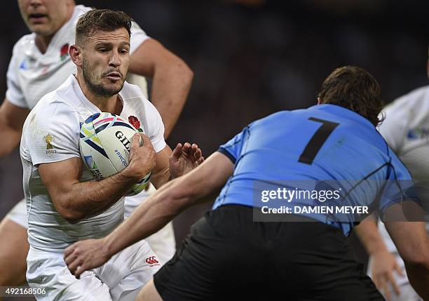 England's scrum half Danny Care runs with the ball during the Pool A match of the 2015 Rugby World Cup between England and Uruguay at Manchester City...