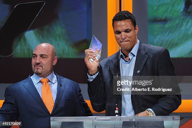 Personality Jay Glazer presents former NFL player Tony Gonzalez with the Lifetime Achievement Award on stage at the 2014 Sports Spectacular Gala at...
