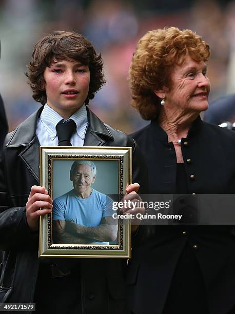 Jamie Hafey-Bagg, grandson of Tom Hafey and Maurreen Hafey the wife of Tom Hafey walk around the boundary line during the public service for Tom...