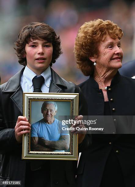 Jamie Hafey-Bagg, grandson of Tom Hafey and Maurreen Hafey the wife of Tom Hafey walk around the boundary line during the public service for Tom...
