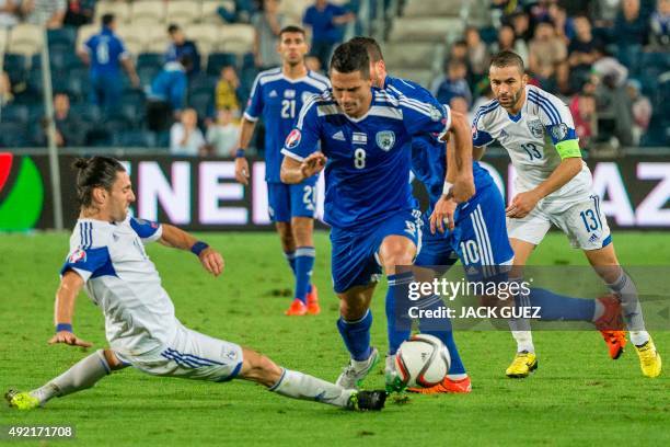 Israeli's midfielder Beram Kayal vies with Cypriot's midfielder Vincent Laban during the Euro 2016 qualifying football match between Israel and...