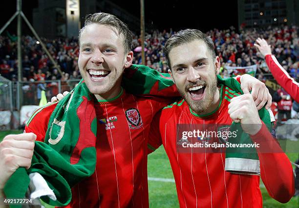 Players of Wales national team Chris Gunter and Aaron Ramsey celebrate the Euro 2016 qualifying football match between Bosnia and Herzegovina and...