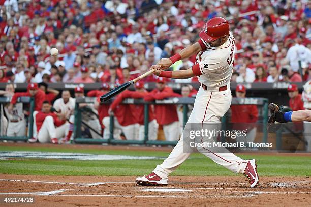 Matt Carpenter of the St. Louis Cardinals hits a solo home run in the first inning against the Chicago Cubs during game two of the National League...