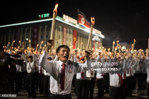 Volunteers take part in a torch-lighting performance at Kim Il-Sung square in Pyongyang on October 10, 2015. North Korea was marking the 70th...