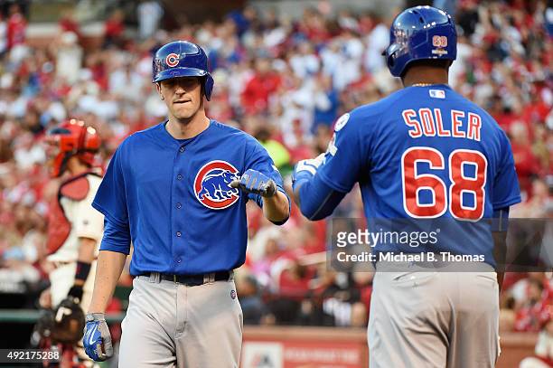 Kyle Hendricks of the Chicago Cubs celebrates with Jorge Soler of the Chicago Cubs after scoring a run in the second inning against the St. Louis...