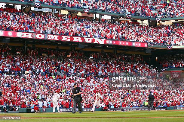 Matt Carpenter of the St. Louis Cardinals runs the bases after hitting a solo home run in the first inning against the Chicago Cubs during game two...