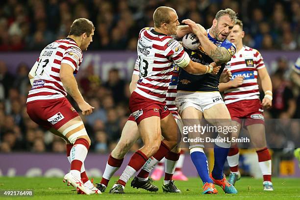 Jamie Peacock of Leeds Rhinos holds the ball in a tackle from Lee Mossop of Wigan Warriors during the First Utility Super League Grand Final between...