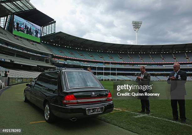 Players form a guard of honour as the hearse does a lap of honour of the ground during the public service for Tom Hafey at Melbourne Cricket Ground...