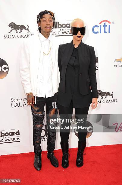 Model Amber Rose and recording artist Wiz Khalifa arrive at the 2014 Billboard Music Awards at the MGM Grand Garden Arena on May 18, 2014 in Las...