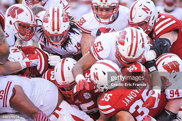 Fullback Andy Janovich of the Nebraska Cornhuskers is smothered by the Wisconsin Badgers defense during their game at Memorial Stadium on October 10,...