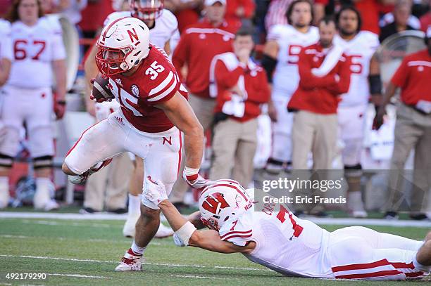 Fullback Andy Janovich of the Nebraska Cornhuskers breaks the tackle of safety Michael Caputo of the Wisconsin Badgers on the way to the end zone...
