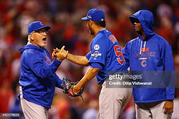 Manager Joe Maddon of the Chicago Cubs celebrates with Hector Rondon of the Chicago Cubs after the Chicago Cubs defeat the St. Louis Cardinals in...