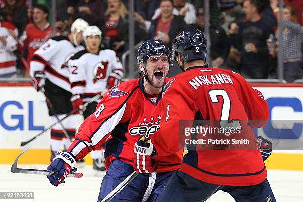 Alex Ovechkin of the Washington Capitals celebrates with teammate Matt Niskanen after scoring a third period goal against the New Jersey Devils at...