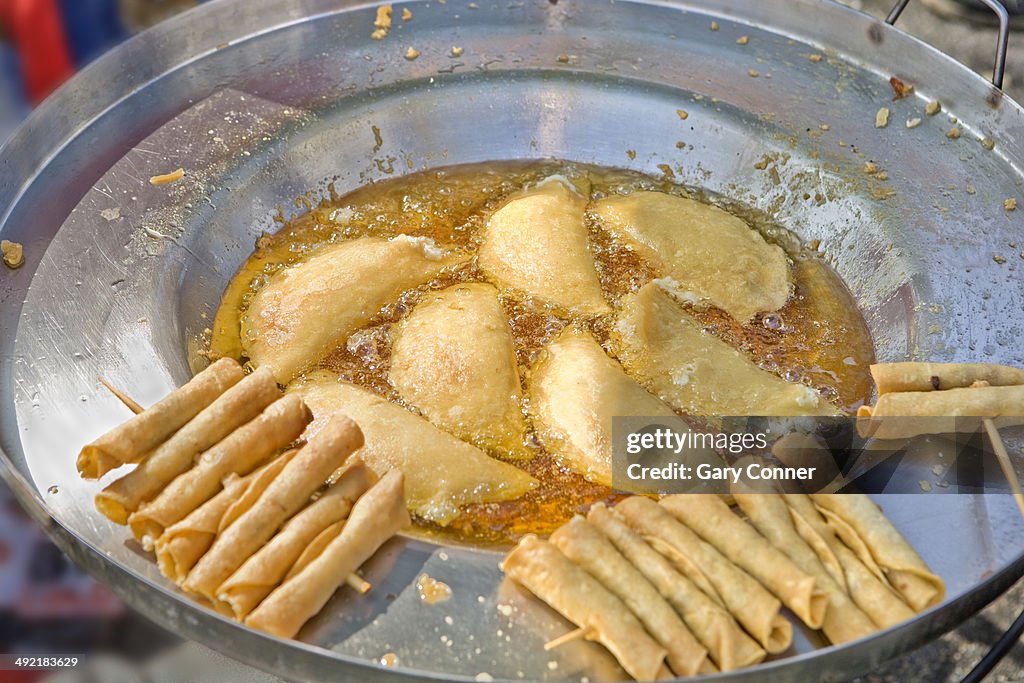 Empanadas and taquitos cooking
