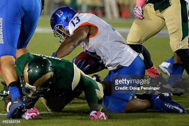Running back Jeremy McNichols of the Boise State Broncos is hit by Kevin Pierre-Louis of the Colorado State Rams on the goal line as McNichols spins...
